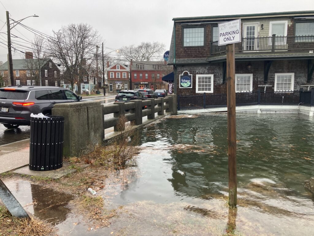 a flooded street with cars and buildings (MyCoast AI)