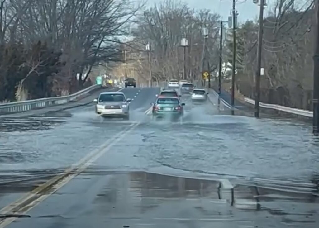 a road with cars on it and a puddle of water on the side (MyCoast AI)