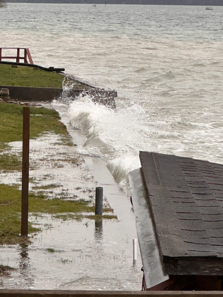a large wave crashing into a dock (MyCoast AI)