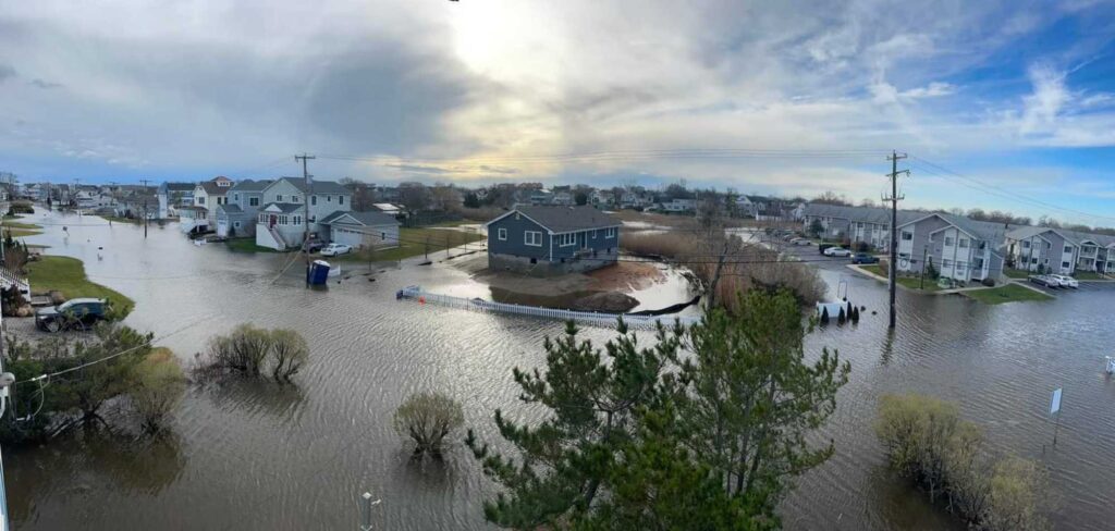 a flooded area with houses and a body of water (MyCoast AI)