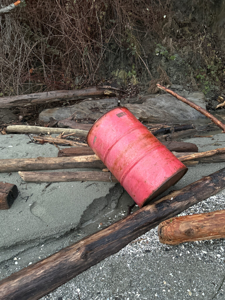a red plastic object on a wooden surface (MyCoast AI)