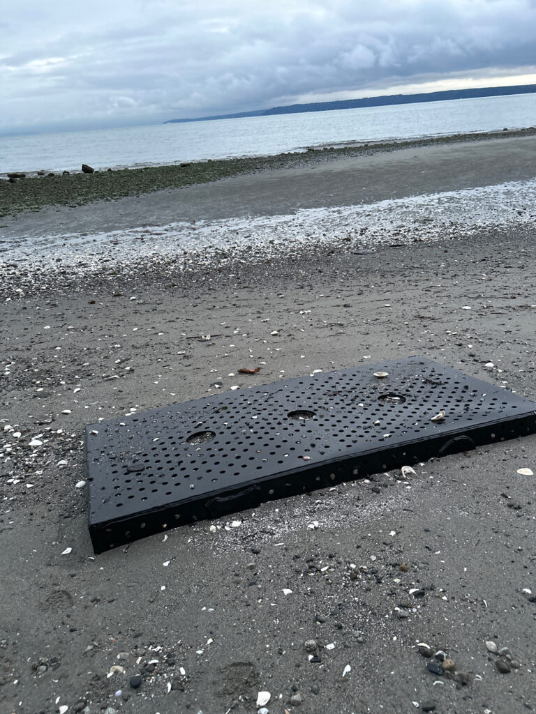 a black rectangular object on a beach (MyCoast AI)