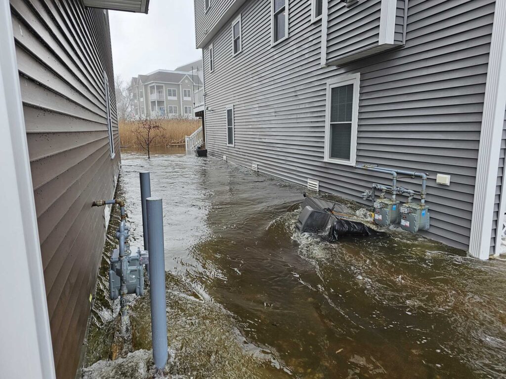 a flooded street with a pile of garbage (MyCoast AI)