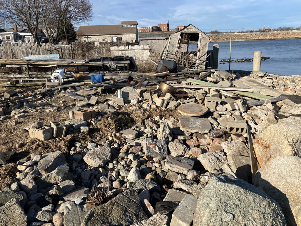 a pile of rocks by a body of water (MyCoast AI)