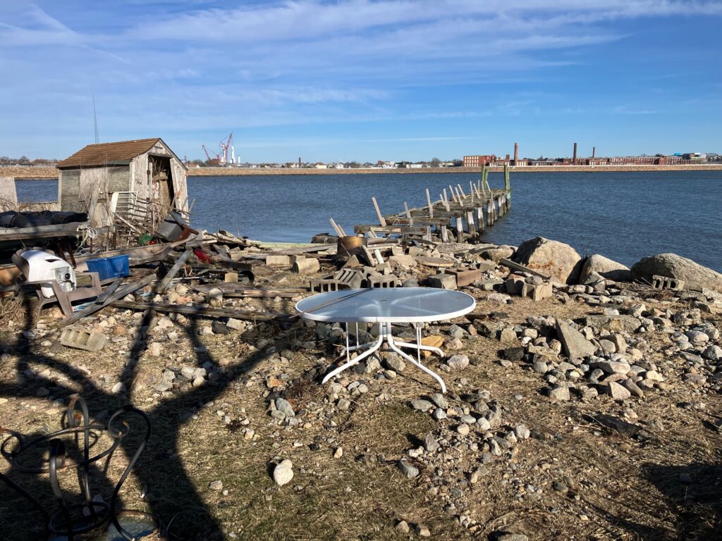 a table and chairs on a rocky beach (MyCoast AI)