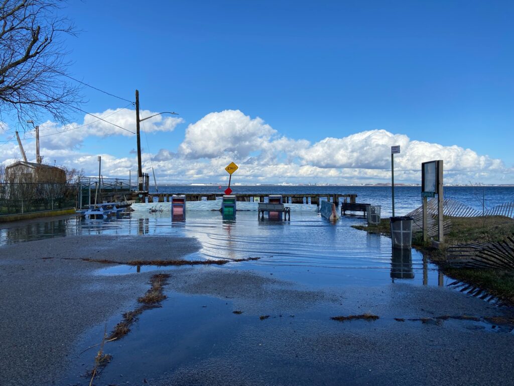a body of water with boats in it and a dock with a sign on it (MyCoast AI)