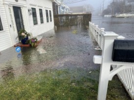 a flooded street with a house and a car parked on the side (MyCoast AI)