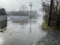 a flooded road with a house (MyCoast AI)
