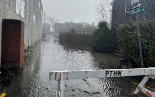 a flooded street with a sign (MyCoast AI)