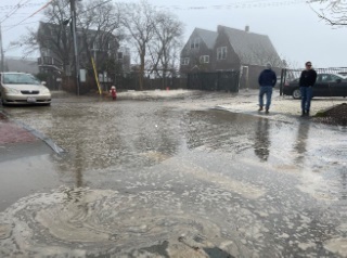 a flooded street with people walking (MyCoast AI)