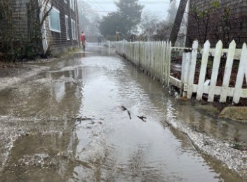 a flooded street with a white fence (MyCoast AI)
