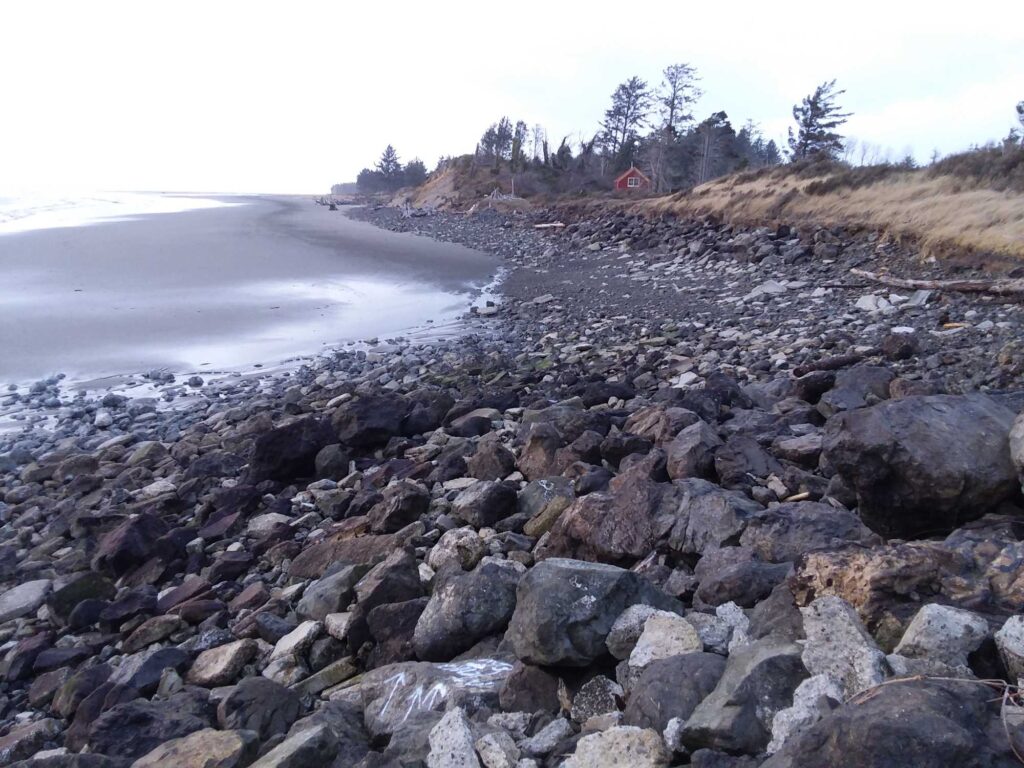 a rocky beach with a body of water in the background (MyCoast AI)