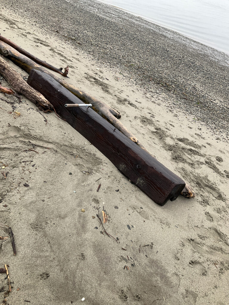 a wood object on a beach (MyCoast AI)