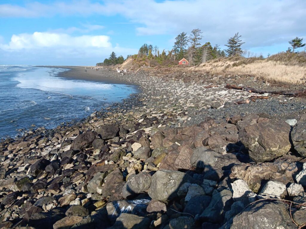 a rocky beach with a small house (MyCoast AI)