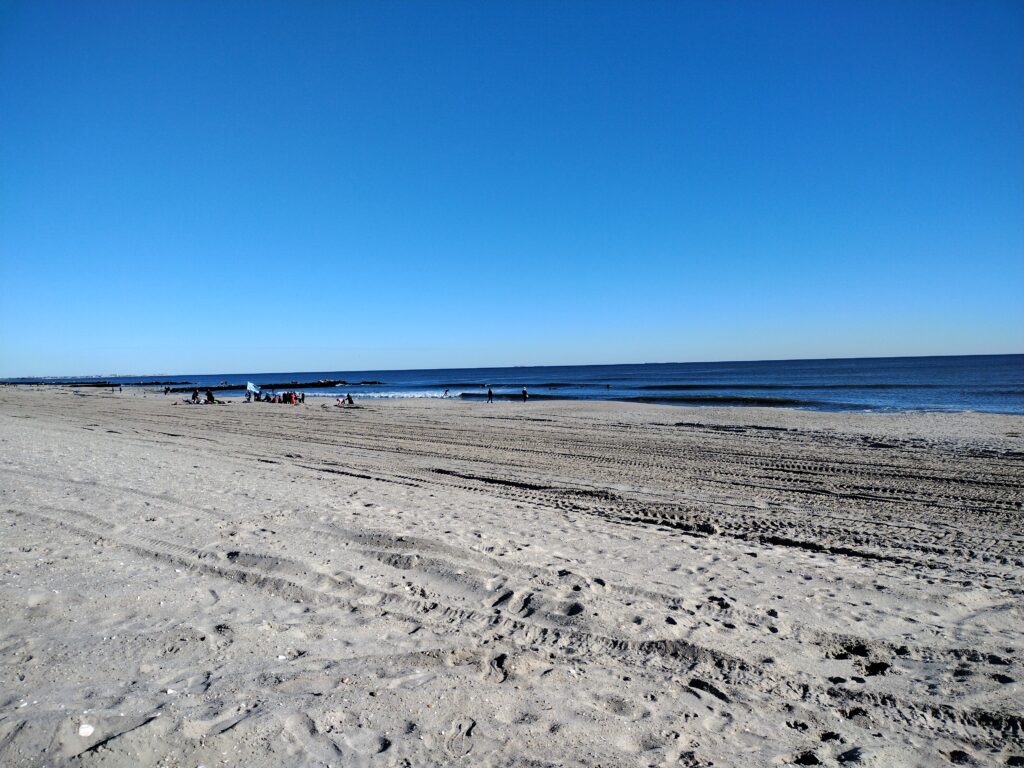 a sandy beach with people walking on it (MyCoast AI)