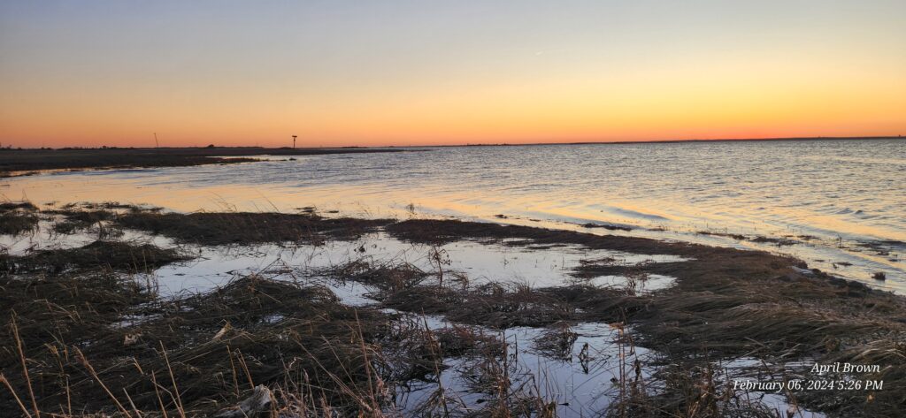 a snowy field with a body of water in the background (MyCoast AI)