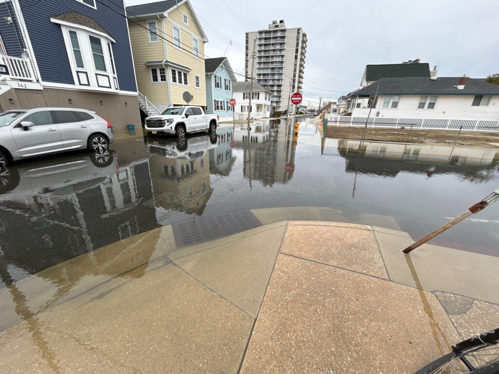 a flooded street with cars and buildings (MyCoast AI)