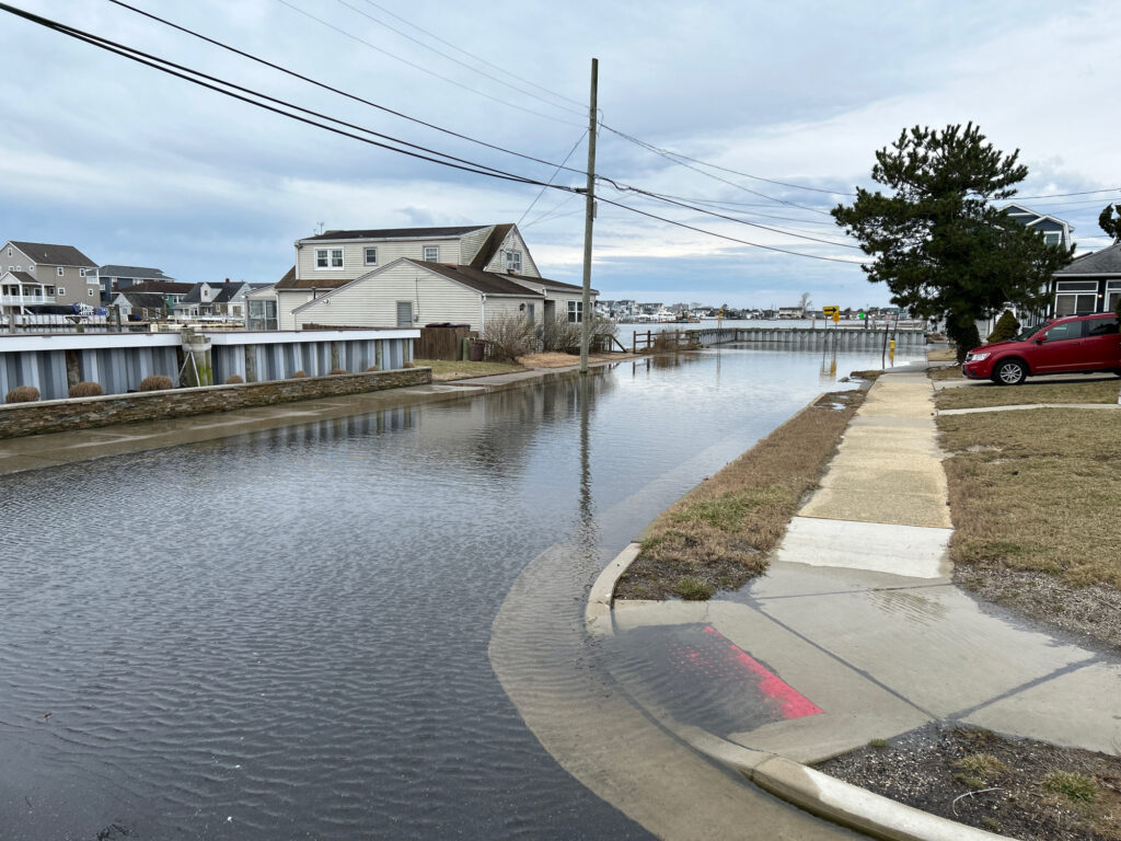 a flooded street with a car parked on the side (MyCoast AI)