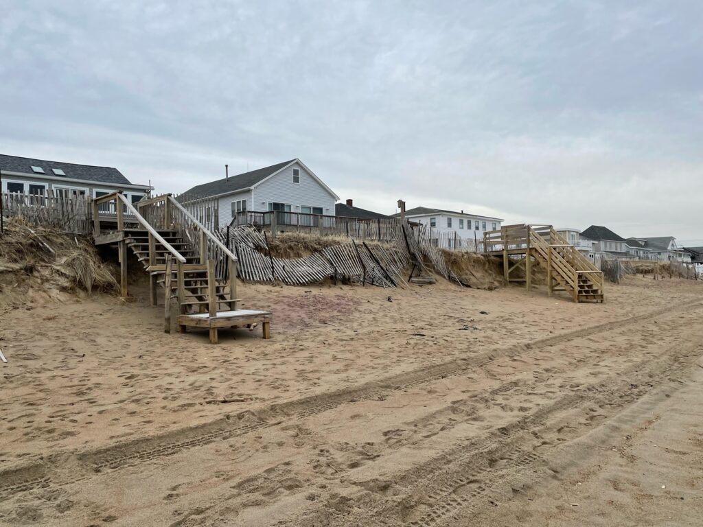 a sand pit with a pile of wood and a pile of wood (MyCoast AI)