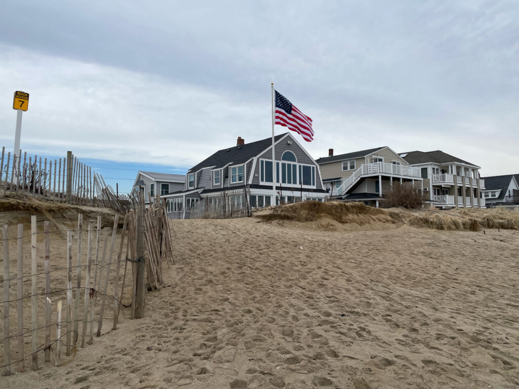 a beach with a flag and a building in the background (MyCoast AI)