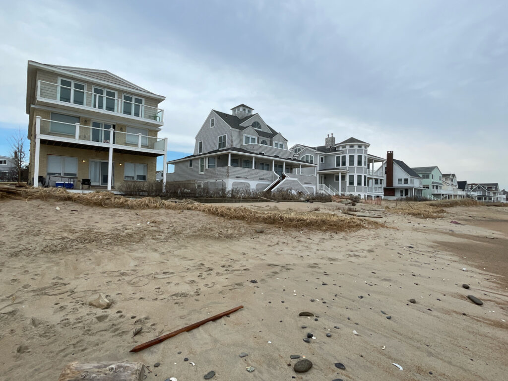 a beach with houses in the background (MyCoast AI)