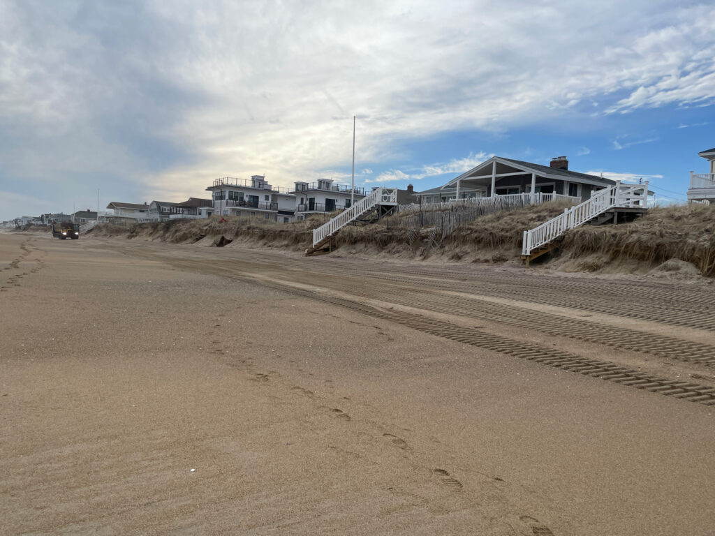 a sandy beach with a building in the background (MyCoast AI)