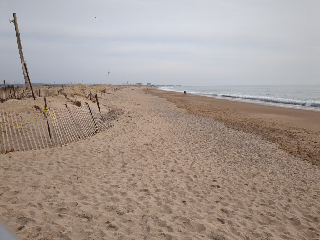 a sandy beach with a fence (MyCoast AI)