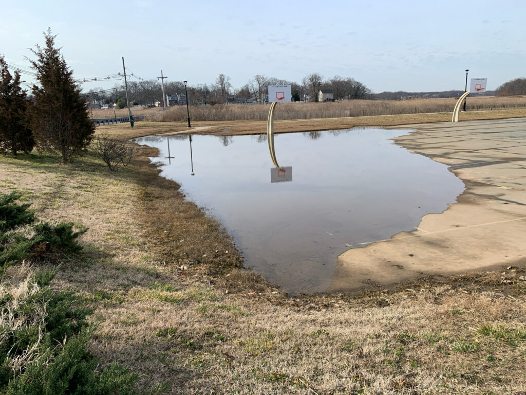a flooded road with a water pipe (MyCoast AI)