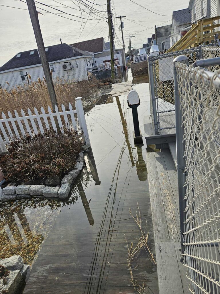 a fenced in walkway with snow (MyCoast AI)