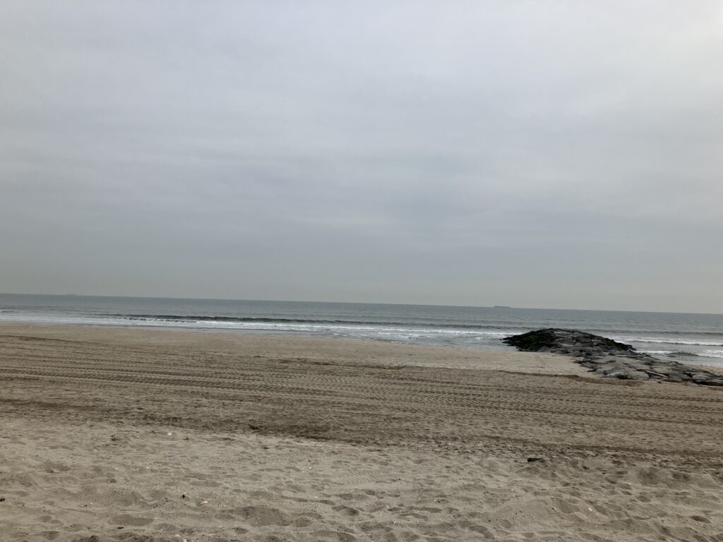 a sandy beach with waves crashing (MyCoast AI)