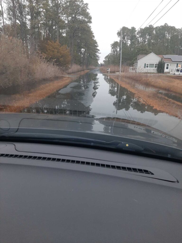 a flooded road with a house (MyCoast AI)