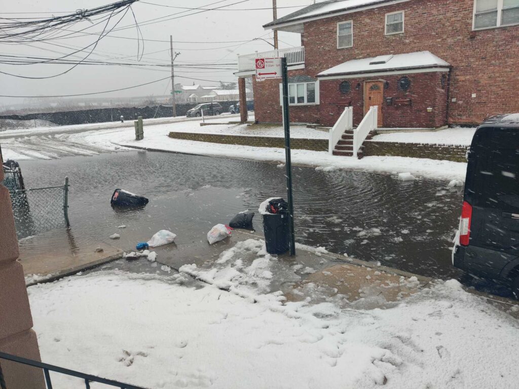 a street with trash cans and a car parked on the side (MyCoast AI)