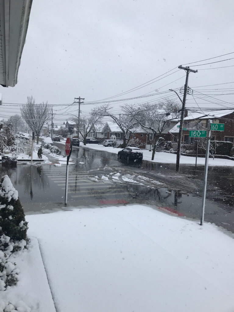 a snowy street with a car parked on the side (MyCoast AI)