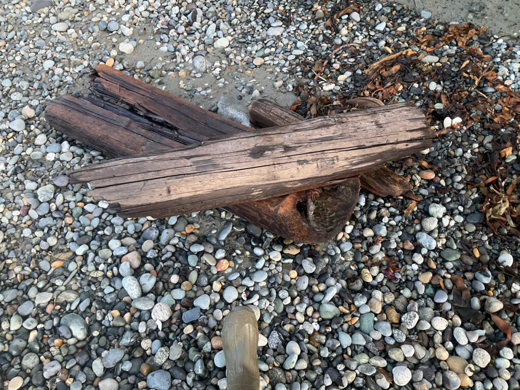 a wooden cross on a rocky surface (MyCoast AI)