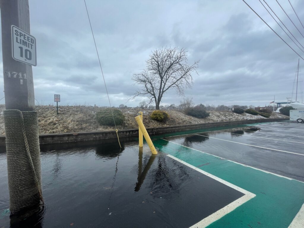a flooded road with a sign (MyCoast AI)