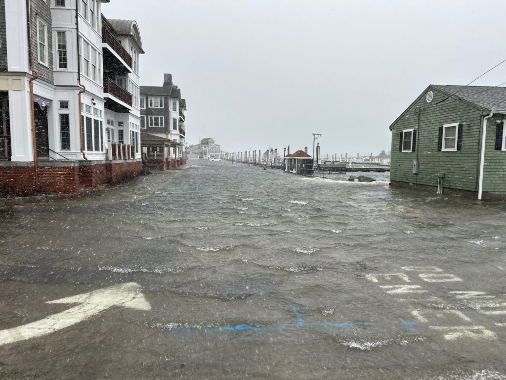 a wet street with buildings on either side of it (MyCoast AI)