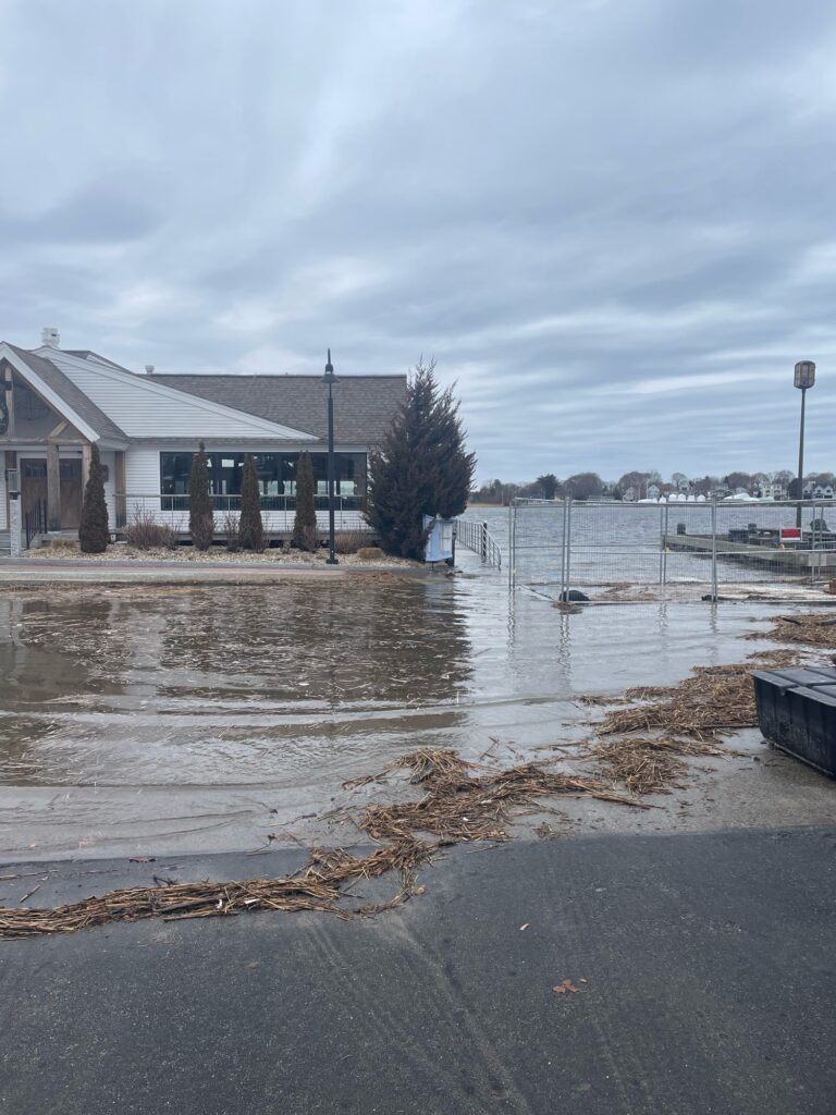 a flooded street with a house and boats (MyCoast AI)