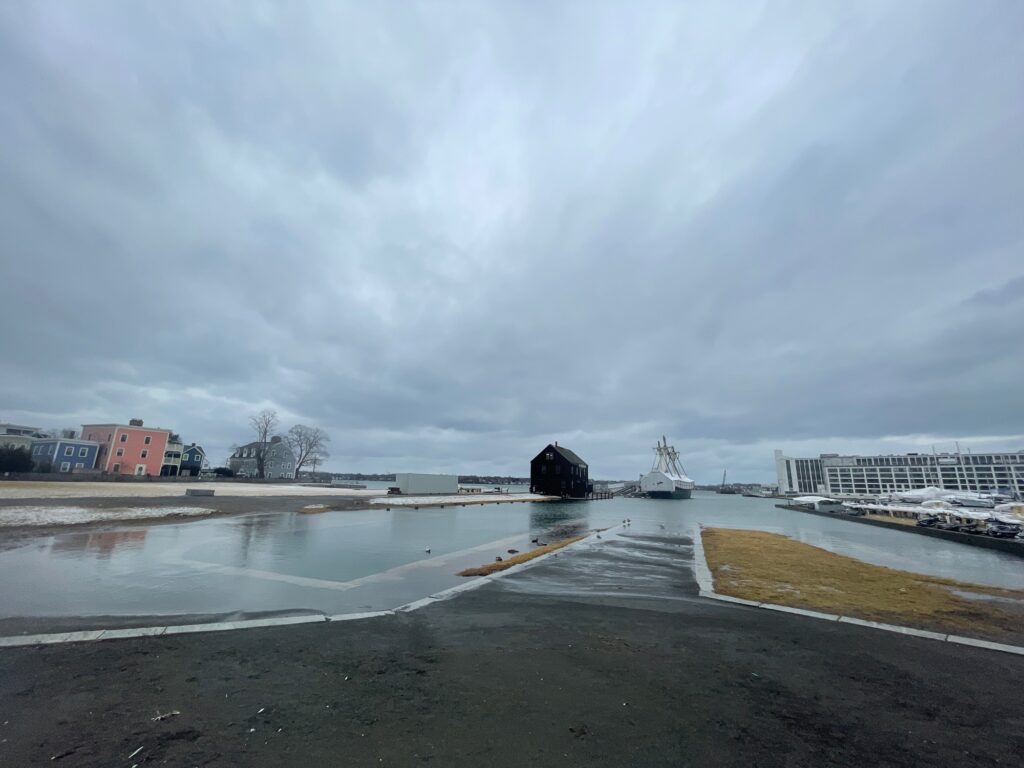 a frozen lake with buildings and a boat in the distance (MyCoast AI)