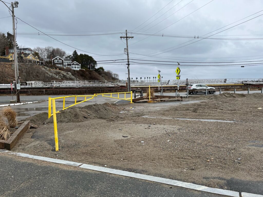 a road with a yellow tape on it and a car on the side (MyCoast AI)