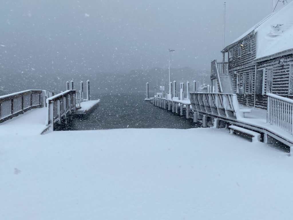a snowy street with buildings and a fence (MyCoast AI)