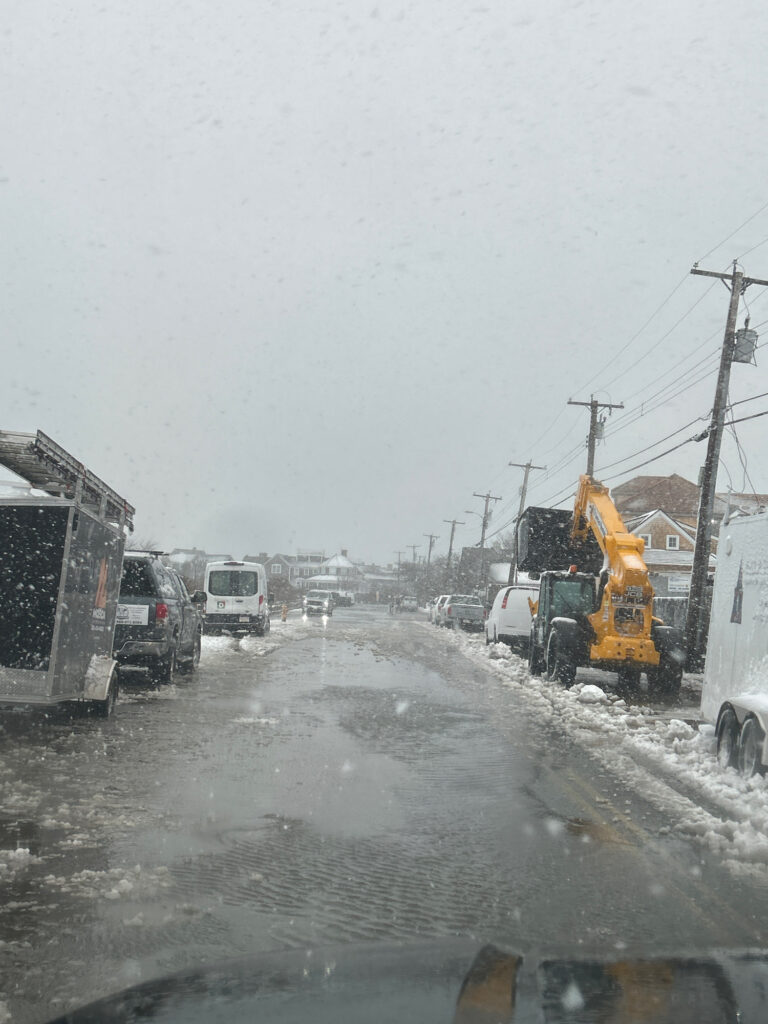 a road with cars and trucks on it and a crane in the distance (MyCoast AI)