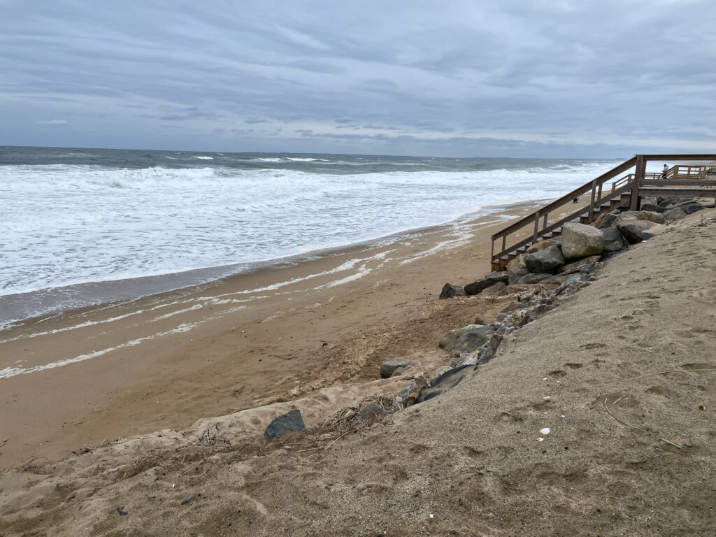 a beach with rocks and a wooden walkway (MyCoast AI)