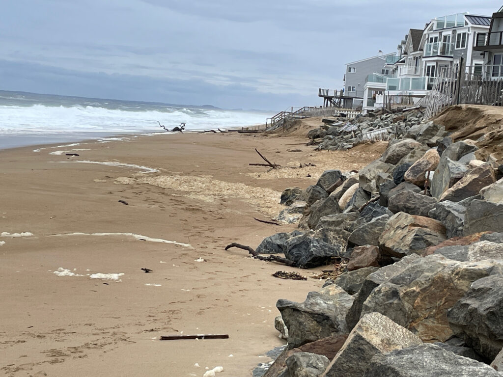 a rocky beach with a building in the background (MyCoast AI)