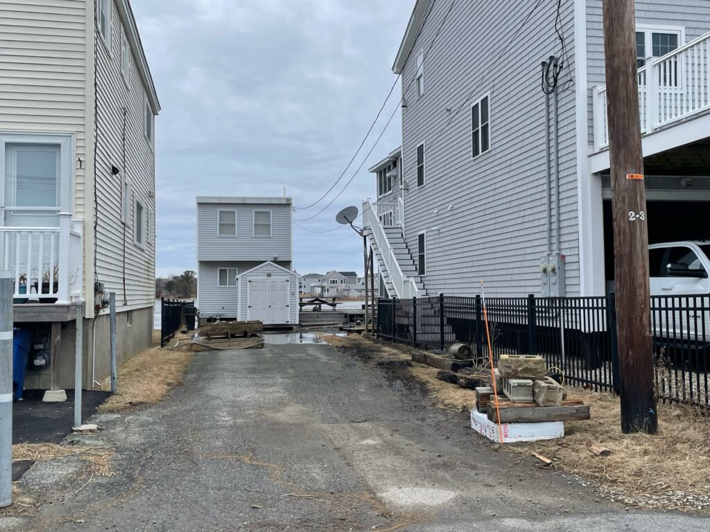 a dirt road between buildings (MyCoast AI)