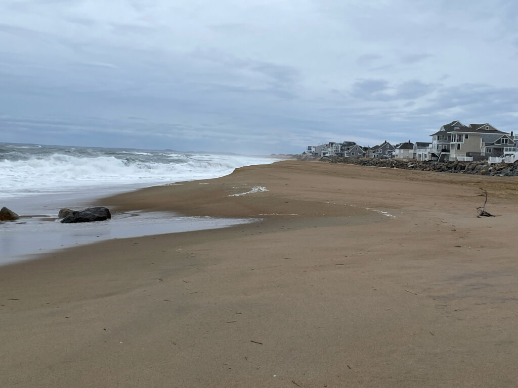 a sandy beach with waves crashing on it (MyCoast AI)