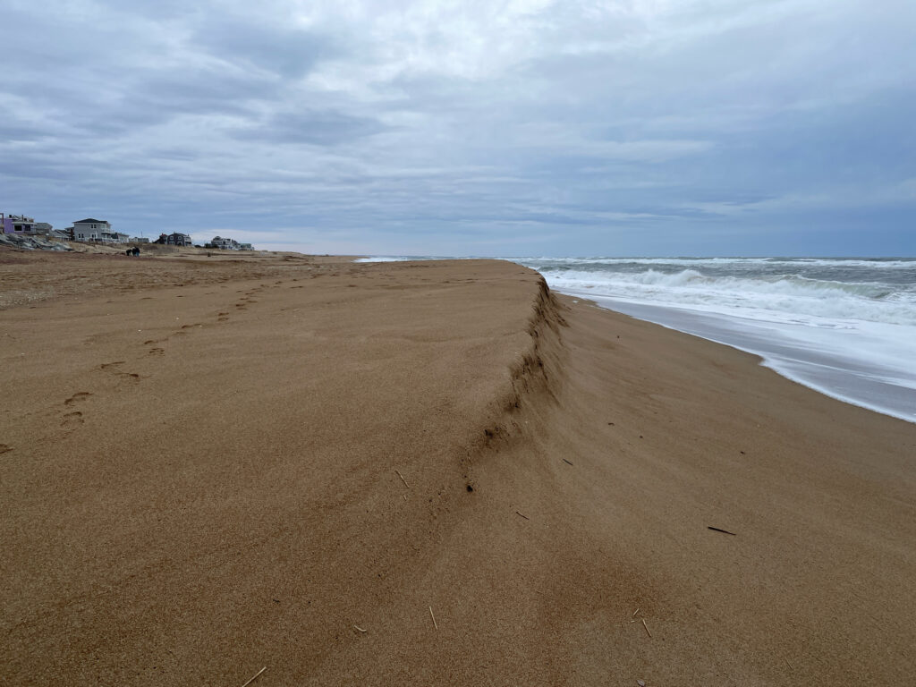a sandy beach with waves crashing on it (MyCoast AI)