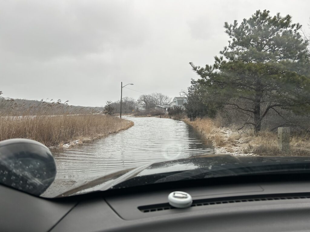 a flooded road with a car driving (MyCoast AI)
