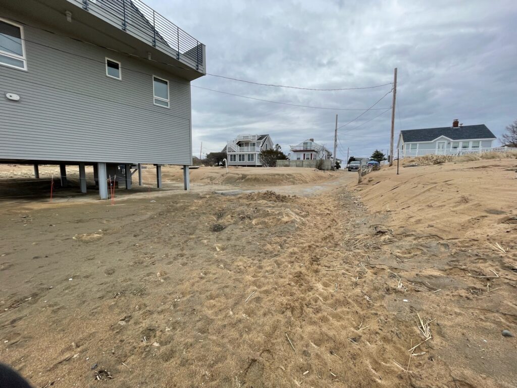 a dirt road between buildings (MyCoast AI)