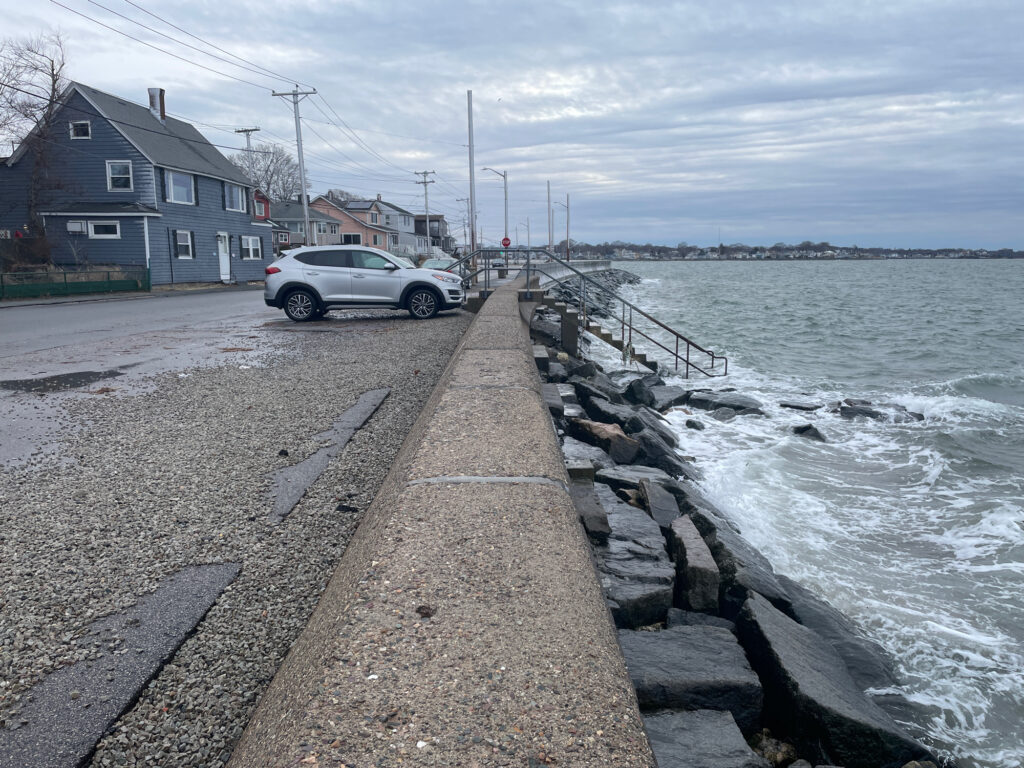 a car parked on the side of a road next to a body of water (MyCoast AI)