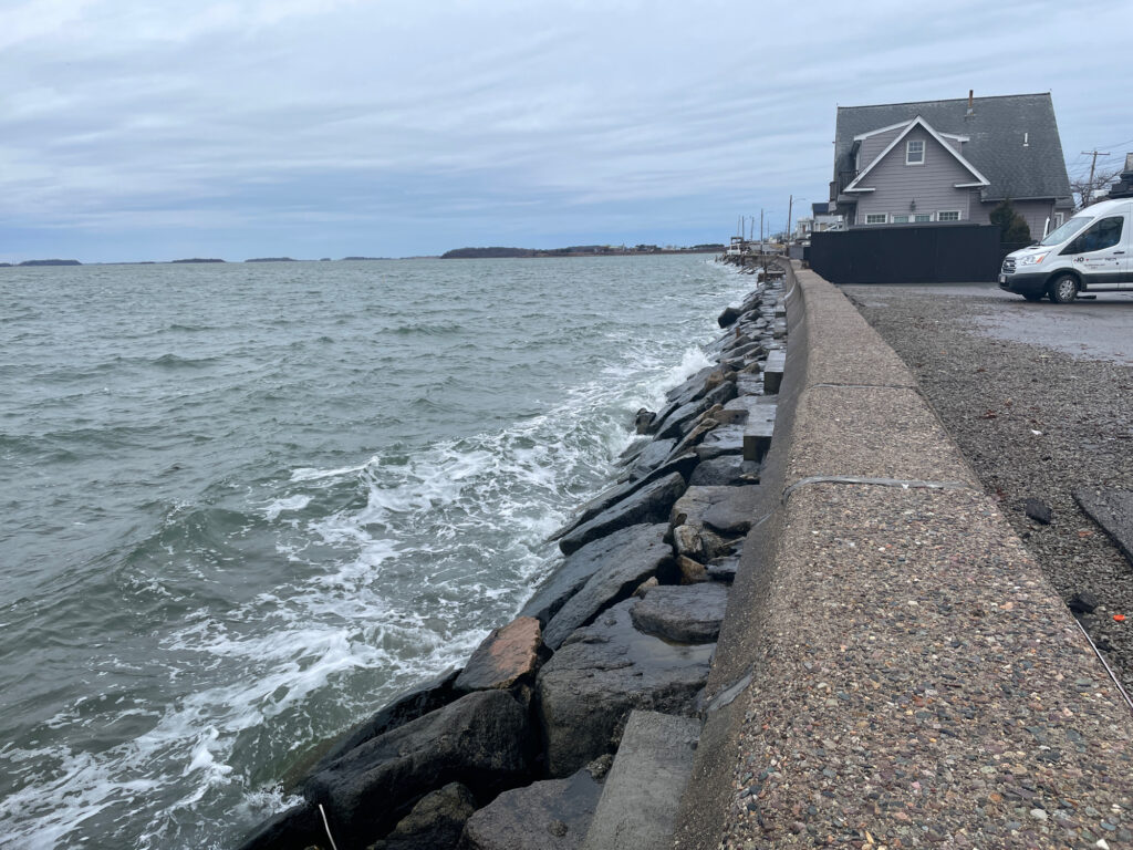 a stone wall next to a body of water (MyCoast AI)